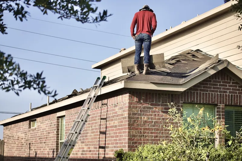 Professional roofer working on a residential roof in Grand Central